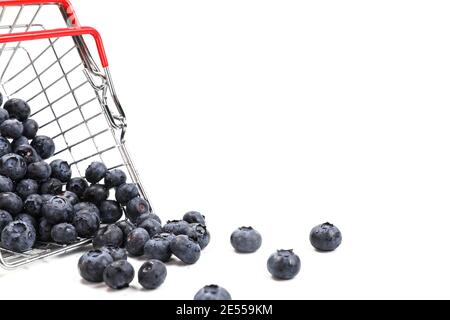 Fresh blueberries falling from metal shopping box isolated on a white background.  Stock Photo