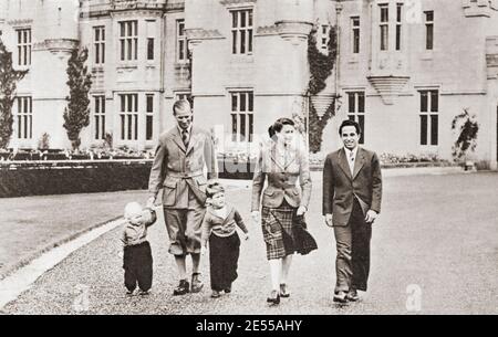 EDITORIAL ONLY Elizabeth II  and The Duke of Edinburgh with Faisal II of Iraq, seen here at Balmoral in 1952.  Elizabeth II, Queen of the United Kingdom,1926 - 2022. Prince Philip, Duke of Edinburgh, born Prince Philip of Greece and Denmark,1921- 2021. Husband of Queen Elizabeth II of the United Kingdom.  Faisal II, 1935 – 1958.  Last King of Iraq.  From The Queen Elizabeth Coronation Book, published 1953.