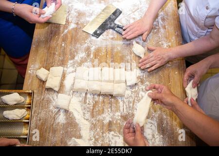 Bread baking process. Women make pies from dough Stock Photo