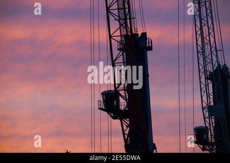 Sassnitz, Germany. 23rd Jan, 2021. A ship lies in the port of Mukran near Sassnitz at sunset. From Mukran, preparations are being made for the further construction of the Nord Stream 2 Baltic Sea pipeline. Since 2016, the Sassnitz-Mukran ferry port has been operating under the name Mukran Port. Credit: Stefan Sauer/dpa-Zentralbild/ZB/dpa/Alamy Live News Stock Photo