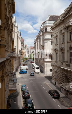 Budapest, Hungary - July 17, 2012: View of the Hungarian Parliament in the distance, from one of the buildings on Akademia Street, on the Pest side, B Stock Photo