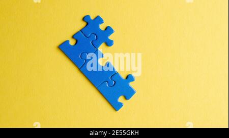 scattered puzzle pieces on colored background Stock Photo
