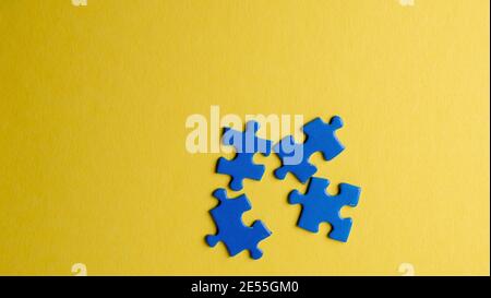 scattered puzzle pieces on colored background Stock Photo