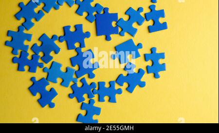 scattered puzzle pieces on colored background Stock Photo