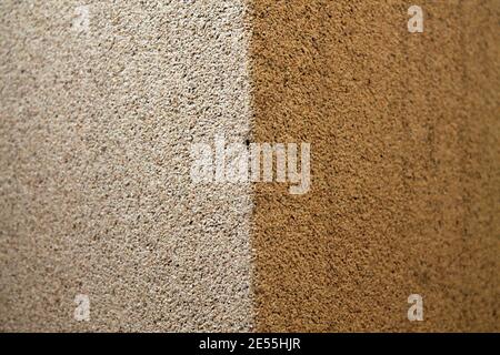 Closeup view of two-sided wall with white and brown bumpy grunge texture backround Stock Photo