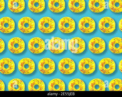 Pattern of yellow donuts on a blue background. Stock Photo