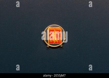 A French postage stamp encased in aluminium (to be used as a coin) c. 1920, Ashmolean Museum, Oxford UK. Stock Photo