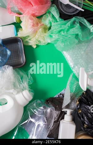 Various types of plastic at green background as a border Stock Photo