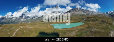 Aerial view of mount Cervino (Matterhorn) and Tramail de Vieille lake from the fields of Plan Maison, Aosta Valley, northern Italy. Stock Photo