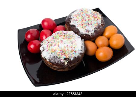 Colorful eggs with easter cake for the holiday. All this is isolated in a whiye background. Close-up. Stock Photo