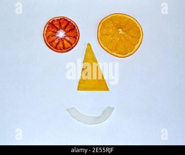 Funny smile face made of dried fruits on white paper background Stock Photo