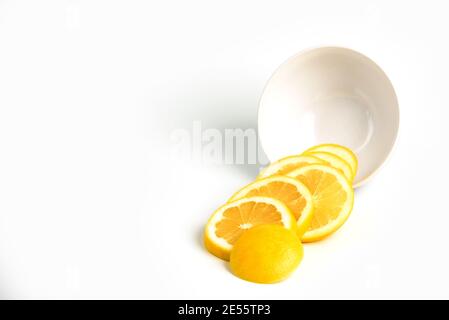 Isolated grapefruits slices out of a bowl. Grapefruit - circular slices of fresh grapefruit isolated on white background with copy space Stock Photo
