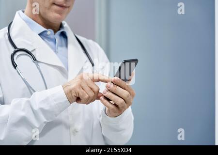 Male doctor using smart phone mobile e health technology, copy space. Stock Photo