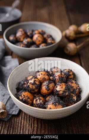 Sweet Slovakian Christmas pastry Opekance also known as Bobalky or Pupaky with poppy seeds on rustic wooden background Stock Photo