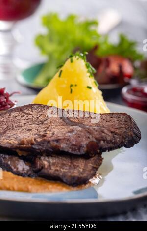 german sauerbraten on a plate with dumplings Stock Photo