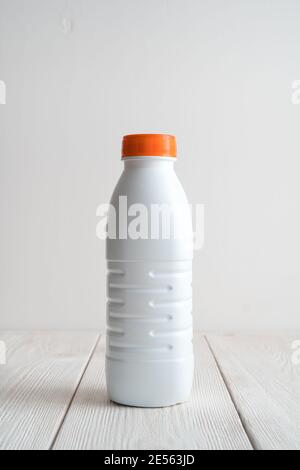 White plastic bottle on a light background. Side view with copy space. Stock Photo