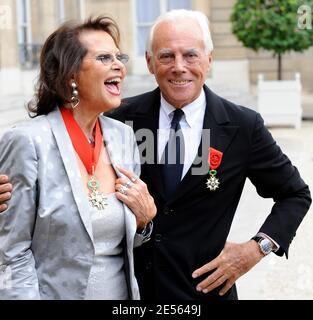 Actress Claudia Cardinale and Italian designer Giorgio Armani pose in the courtyard of the Elysee Palace in Paris, France on July 3, 2008, after being awarded with France's most prestigious Legion d'Honneur medal by French President Nicolas Sarkozy. Photo by Orban-Taamallah/ABACAPRESS.COM Stock Photo