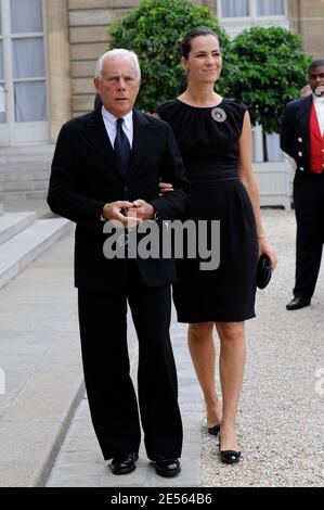 Italian designer Giorgio Armani poses with wife Roberta in the courtyard of  the Elysee Palace in Paris, France on July 3, 2008, prior to be awarded  with France's most prestigious Legion d'Honneur