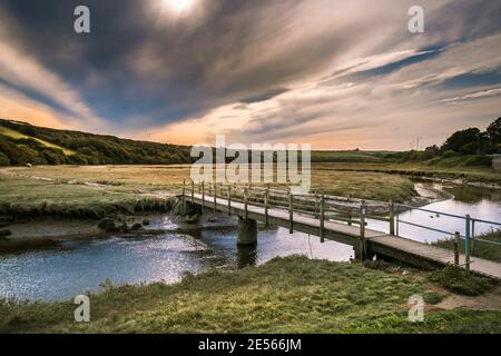 Early evening sunlight over the River Gannel at low tide in Newquay in Cornwall. Stock Photo