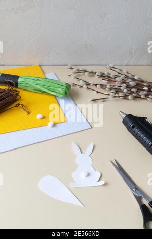 How to make an Easter garland of rabbits and carrots with your own hands from felt. Step by step instruction. Step 3. Cut out from paper. Stock Photo