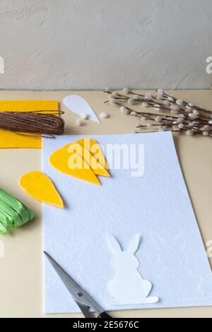 How to make an Easter garland of rabbits and carrots with your own hands from felt. Step by step instruction. Step 6. Outline the rabbits on felt. Stock Photo