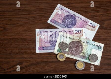 Polish money zloty, coins and banknotes on a wooden table. Stock Photo