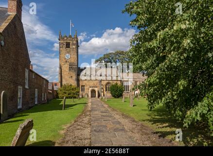 All Hallows Church and gravestones in summer Sutton on the Forest near York. Stock Photo