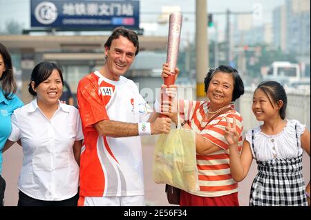CEO of Carrefour China Eric Legros poses with the olympic flame