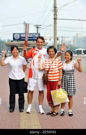 CEO of Carrefour China Eric Legros poses with the olympic flame