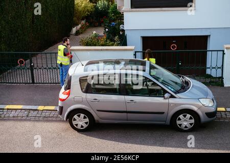 Paris, France - Oct 17, 2018: Two students from the architecture university measuring the distances on the street as an outdoor lesson Stock Photo
