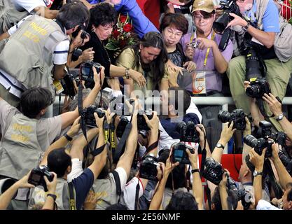 Michael Phelps of the United States greets his family, sister's Whitney and Hilary and mother Debbie in the stands as he is surrounded by photographers after receiving his gold medal in the Men's 4x100 Medley Relay at the XXIX Beijing Olympic Games Day 9 at the National Aquatic Center in Beijing, China on August 17, 2008. Photo by Willis Parker/Cameleon/ABACAPRESS.COM Stock Photo