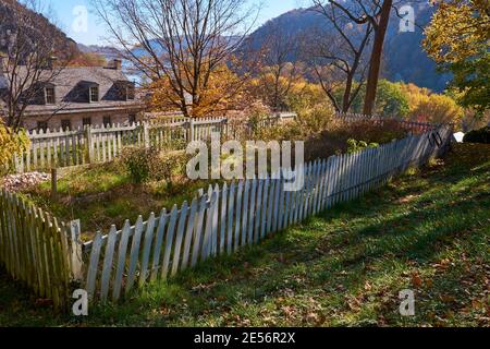 An old, small, humble cemetery, graveyard with a white picket fence. During fall, autumn in Harpers Ferry, West Virginia. Stock Photo