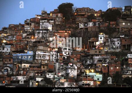 'Some giant photographes of a woman's eyes cover the walls of homes in Providencia slum in Rio de Janeiro, Brazil, on August 16, 2008. A French photographer who identifies himself as JR is exhibiting portraits of women whose loved ones were killed by police as part of his project entitled '28 mm'. 'Morro da Providencia' is one of the most dangerous favela in Rio de Janeiro. From some days, the facades of the poor houses of this slum watch to the city with great eyes that worry and observe the people walking down the hill. The eyes belong to the photographic project of JR, www.jr-art.net, a Fre Stock Photo