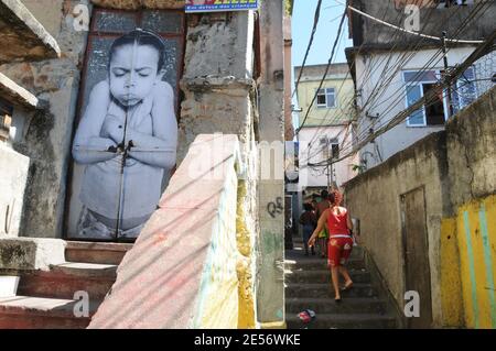 'One of the giant photographes that covers the walls of the homes in Providencia slum in Rio de Janeiro, Brazil, on August 16, 2008. A French photographer who identifies himself as JR is exhibiting portraits of women whose loved ones were killed by police as part of his project entitled '28 mm'. 'Morro da Providencia' is one of the most dangerous favela in Rio de Janeiro. From some days, the facades of the poor houses of this slum watch to the city with great eyes that worry and observe the people walking down the hill. The eyes belong to the photographic project of JR, www.jr-art.net, a Frenc Stock Photo