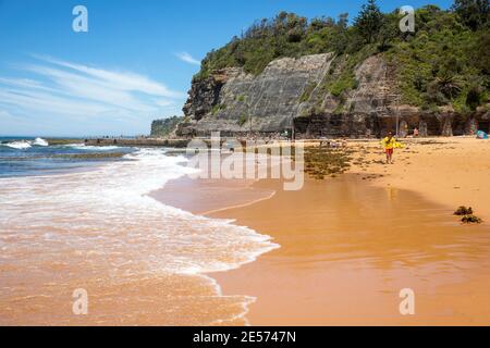 Bilgola Beach Sydney and view of ocean pool with rockfall netting installed on the cliff face to prevent rocks falling on people,Sydney,Australia Stock Photo