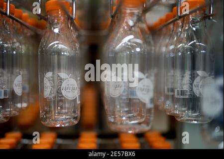 detail of empty plastic juice bottles stored in a rack ready for filling Stock Photo