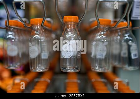 detail of empty plastic juice bottles stored in a rack ready for filling Stock Photo