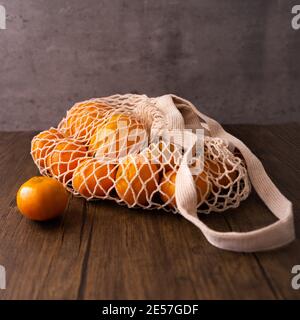 Net bag with many fresh ripe tangerines, closeup Stock Photo - Alamy