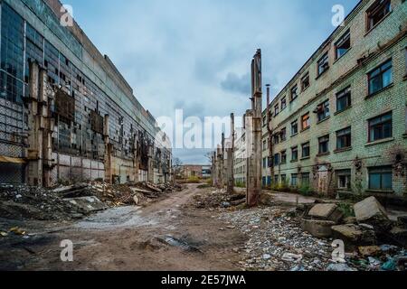 Territory of abandoned industrial area waiting for demolition. Broken buildings. Former Voronezh excavator factory. Stock Photo