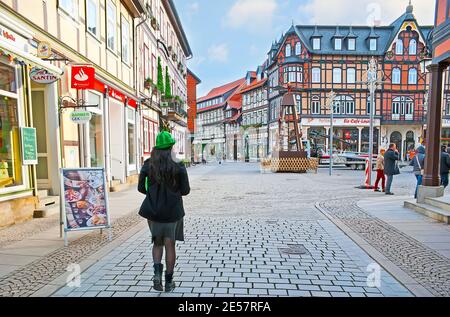WERNIGERODE, GERMANY - NOVEMBER 23, 2012: The Breite Strasse (street) boasts lots of colorful half-timbered houses with restaurants and souvenir store Stock Photo