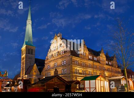 The tall belfry of the St Nicholas Market Church next to the Wedding House with chimes, located in old town of Hamelin, Germany Stock Photo