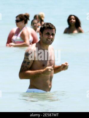 Italian soccer star Christian 'Bobo' Vieri and super hot girlfriend Melissa Satta enjoy the sun and surf on Miami Beach, Fla. 6/3/07.  [[tag]] Stock Photo