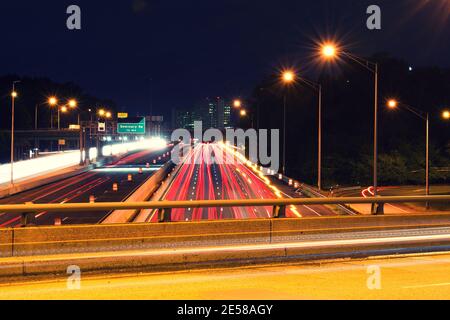 Light trails from vehicles traveling on the interstate 395,  view of the highway from overpass road. Stock Photo