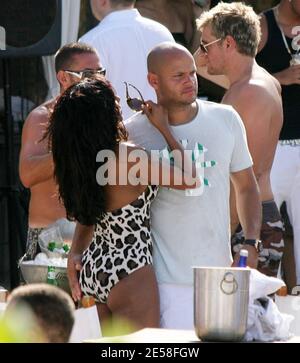 Mel B and boyfriend Stephen Belafonte leave their luxury hotel to go to a popular Miami Sunday afternoon beachside dance club. On arriving, the Spicegirl took off her canary yellow dress to reveal her animal print swimsuit which also revealed how bootylicious she has become. The couple partied the day away with pals and much champagne and beer was consumed at their table. Miami Beach, Fla. 8/5/07.   [[tag]] Stock Photo