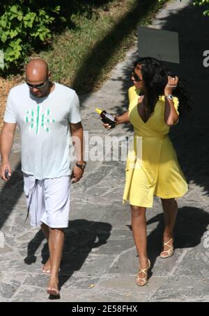 Mel B and boyfriend Stephen Belafonte leave their luxury hotel to go to a popular Miami Sunday afternoon beachside dance club. On arriving, the Spicegirl took off her canary yellow dress to reveal her animal print swimsuit which also revealed how bootylicious she has become. The couple partied the day away with pals and much champagne and beer was consumed at their table. Miami Beach, Fla. 8/5/07.   [[tag]] Stock Photo