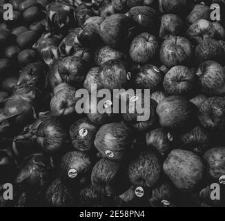 Grayscale shot of a pile of apples and some fresh fruits Stock Photo