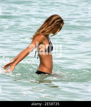 Supermodel Gisele BŸndchen chills out with a friend on Miami Beach