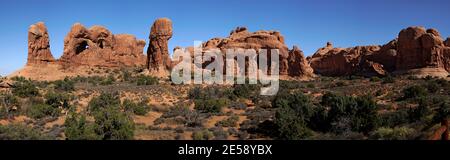 Panoramic image of the Double Arch, with additional geologic formations on either side, in Utah's Arches National Park, USA Stock Photo