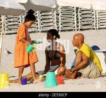 Hip Hop Mogul Russell Simmons takes daughters Ming Lee and Aoki Lee Kyoko to play sandcastles with his new girlfriend, model Porschla Coleman. Ex wife Kimora is also in town doing a personal appearance. Miami Beach, FL. 12/5/07.   [[tag mab]] Stock Photo