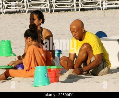 Hip Hop Mogul Russell Simmons takes daughters Ming Lee and Aoki Lee Kyoko to play sandcastles with his new girlfriend, model Porschla Coleman. Ex wife Kimora is also in town doing a personal appearance. Miami Beach, FL. 12/5/07.   [[tag mab]] Stock Photo